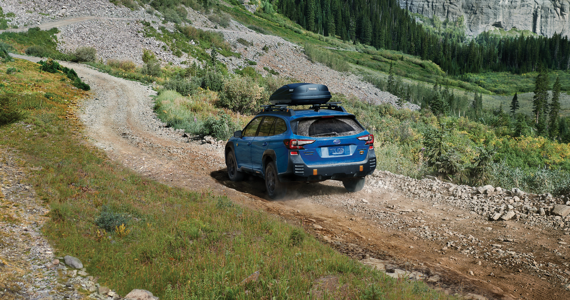 A 2023 Outback Wilderness driving on a trail in the mountains. | Subaru Superstore of Chandler in Chandler AZ